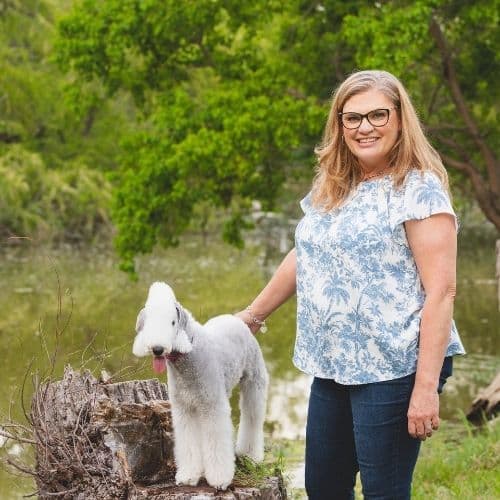 Kim standing with a medium sized dog
